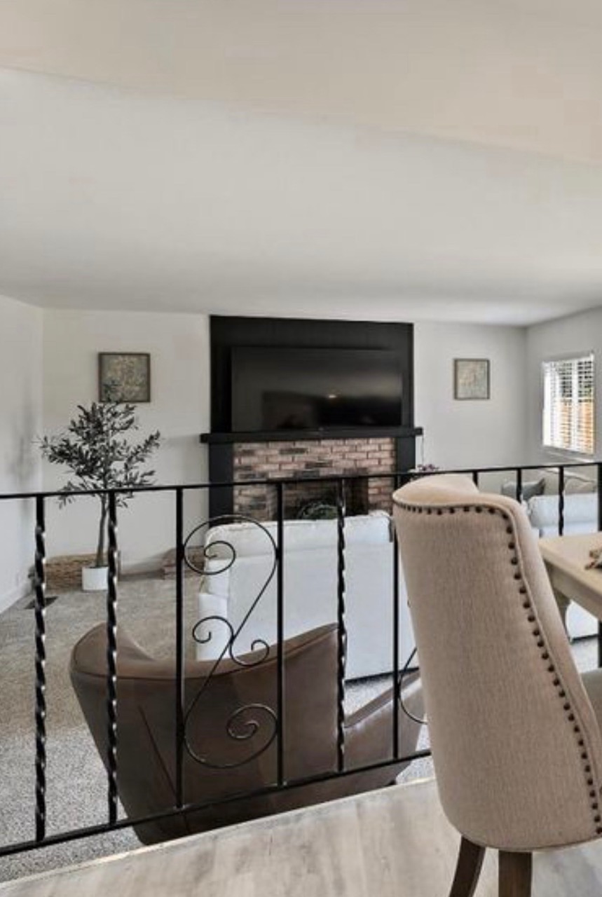 Family room before remodel with wrought iron railing