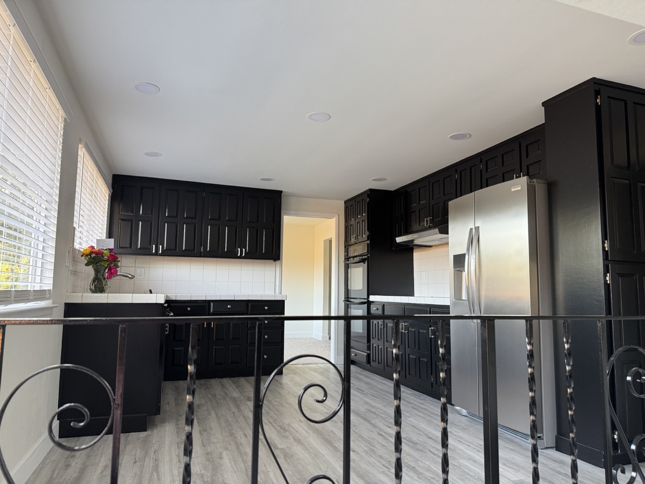 Kitchen before remodel with dark cabinets and tile counters
