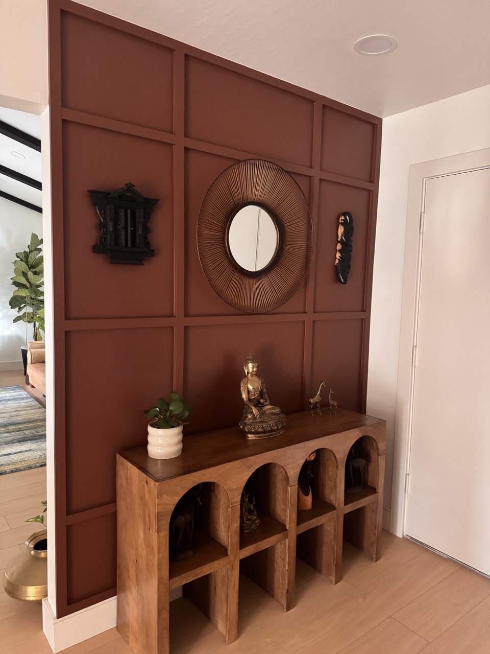 Entryway after remodel with terracotta panel wall and arched console
