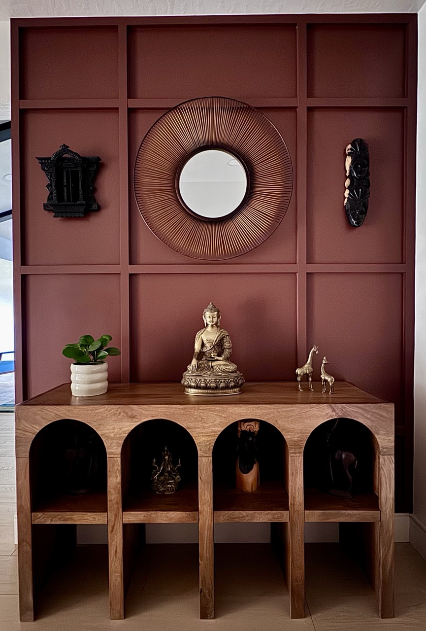Entryway detail with sunburst mirror and brass Buddha