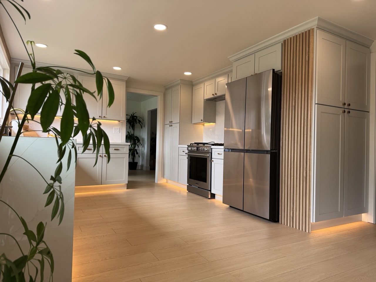 Kitchen after remodel with dove-grey shaker cabinets and fluted oak column