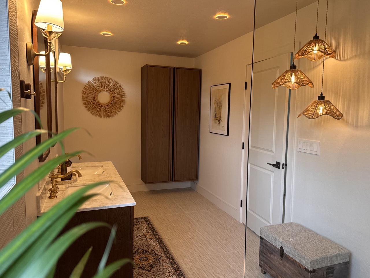 Primary bath after — double vanity with brass fixtures